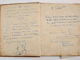 an old book with writing on it sitting on top of a table