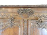 a wooden armoire with a basket of flowers on it