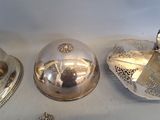 three silver objects on a table with a white background