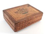 a small wooden box with a floral design on it