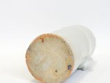 a close up of a white vase on a white surface