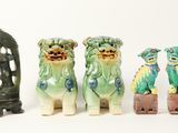 three figurines of dogs sitting next to each other