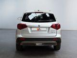the rear end of a white suv parked in a room