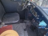 a hat sitting on the seat of an old car