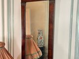 a lamp and a mirror on the wall in a room