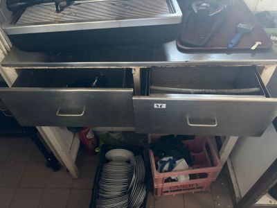 a kitchen with a sink, stove, and a dishwasher in it