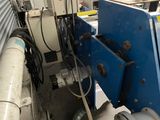 a picture of a machine that is working on a piece of machinery