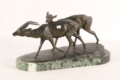 statue of two antelope running on a marble base on a white background