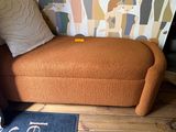 a couch and a rug in the corner of a room