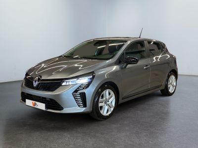 a silver car is parked in a room with a white wall