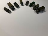 several toy trains are lined up on a white surface