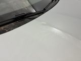 the windshield of a white car with dirt on the windshield