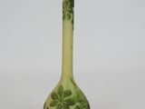 a green vase that has a design on it