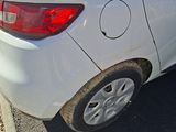 a white car that has been damaged and is parked on the side of the road