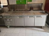 a kitchen with a sink, stove, and refrigerator in it