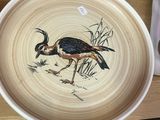 une assiette sur laquelle est représenté un oiseau, à côté d'une assiette sur laquelle est représenté un oiseau