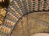 a wicker chair that is sitting on the floor