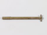 an old brass pipe on a white surface with a white background