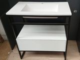 a white sink and a black cabinet in a room