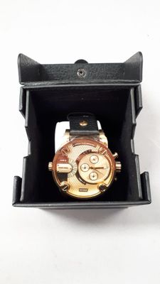 a watch in a black box on a white surface