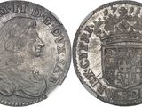 a close up of a coin with a crown on top of it