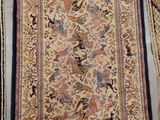 a close up of two rugs on a floor with different colors and patterns