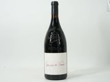 the bottle of red wine is sitting on the table