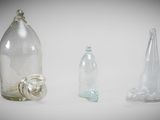three empty glass bottles and one empty glass bottle on the table