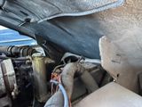 a close up view of a car engine with the hood open