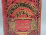 a red book with gold lettering on it sitting on a white surface