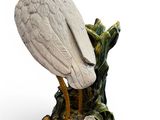 a bird that is sitting on top of a tree stump