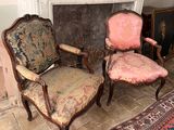 two chairs that are sitting in front of a fire place