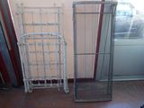 two metal racks that are next to each other on the floor