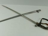two swords and a clamp on a white table