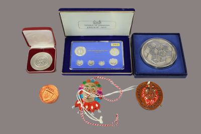 a box with a medal, a medal, a medal, a medal, a medal, and a medal in it