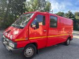 une camionnette rouge garée sur un parking
