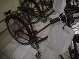 many bicycles that are parked in a room together
