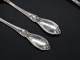 two spoons that are sitting next to each other