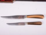 three knives that are sitting next to each other on a table
