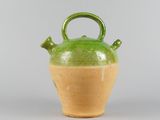 a green and brown vase with a handle on it