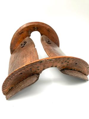 pair of old wooden shoes on a white background