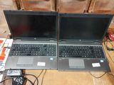 two open laptop computers sitting on top of a table next to each other