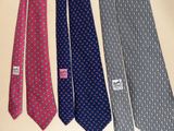 four ties are lined up in a row on a table