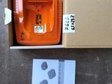 a box that has a small orange tool in it