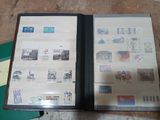an open book with stamps on it sitting on a table