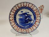 a blue and white plate with a bird on it
