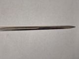 a close up of a knife on a table with a white background