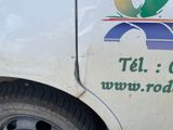 a white truck with a logo on the side of it