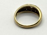 a close up of a gold ring on a white surface
