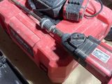 a red tool box with two tools on top of it